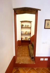 a hallway in a house with a book shelf at La Tonnaia in Lari