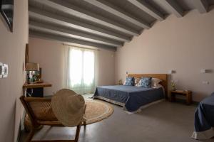 a bedroom with a bed and a large window at La Segreta Country House Planeta in Menfi