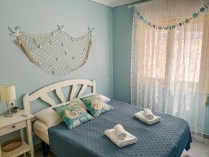 En eller flere senge i et værelse på Casa Marina