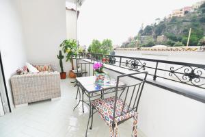 a balcony with a table and chairs and a view at Casa Mulini in Positano