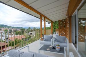 a patio with a couch and a table on a balcony at Piramida Visoko in Visoko