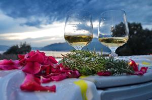 a table with two glasses of wine and a cake at Boka View by Roši in Tivat