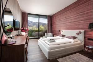 A bed or beds in a room at Senses Violett Suites - Adults Only