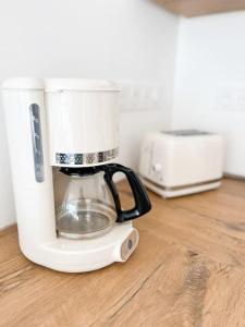 a blender sitting on top of a wooden floor at Villa Molène jacuzzi et plage à 500 m in Tréveneuc