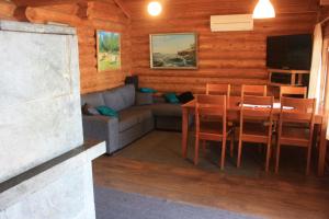 a living room with a couch and a table at Koivurannan Lomamökit Mänty in Nykälä