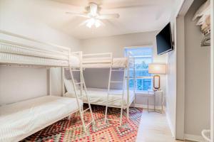 セント・オーガスティンにあるPet-friendly 3 BR Modern Space, 5 min to Downtownのベッドルーム1室(二段ベッド2台、薄型テレビ付)が備わります。