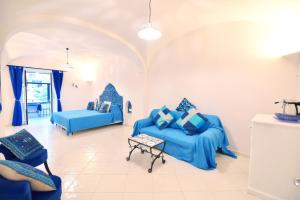 a living room with two blue couches and a table at Casa Mulini in Positano