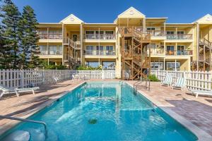 an apartment building with a swimming pool and a resort at Ocean Club at Turtle Mound 207 in New Smyrna Beach