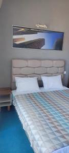 a bedroom with a bed with a headboard at Hotel Neptun - Lozenets in Lozenets