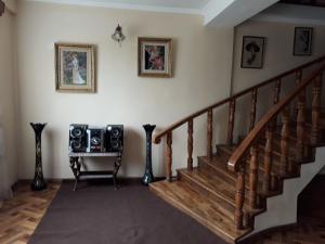 a room with stairs and a table with speakers at Guest house Gio in Kobuleti