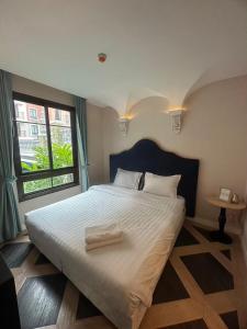 a bedroom with a large bed with a large window at Espana Condo Resort Pattaya Sai2 in Pattaya South +43 photos
