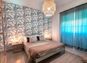 a bedroom with a large bed with a large wallpaper at Villa Rosa - Sperlonga Vertice Rooms in Sperlonga