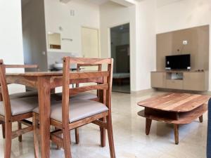 a dining room with a wooden table and a chair at SSN Home Stays in Bangalore near PLAY Arena in Bangalore