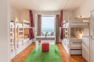 Hostel Casa La Cha في نوفاليا: غرفة مع سرير بطابقين مع طاولة ونافذة