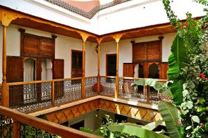 an external view of a house with wooden balconies at Riad Djebel in Marrakesh