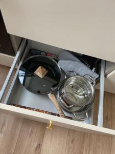 a drawer with a plate and a mirror in a cabinet at Vilkmerge apartment in Ukmergė +16 photos