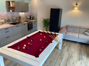 a kitchen with a pool table in a living room at Ferienhaus mit privatem Pool in Soltau