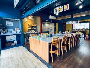 a restaurant with a long table and chairs at SNOOPYと過ごす一棟貸しの宿 ーacchicocchi hideoutー in Fukushima