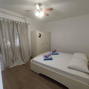 Postel nebo postele na pokoji v ubytování Apartments Jakovljevic + 20 fotografií