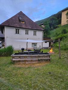 a backyard with a fire pit in front of a house at Wohnung im Nationalpark Kalkalpen 3 in Reichraming +5 photos