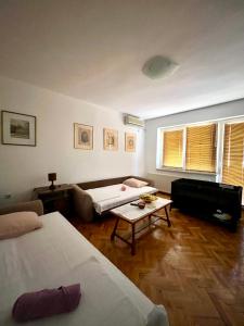 a living room with two beds and a couch at City Apartment Gevgelija in Gevgelija
