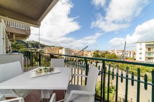 a white table and chairs on a balcony with a view at Estate4home- Casa Bella in Sorrento