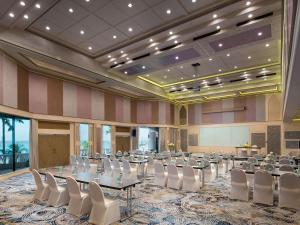 a banquet hall with tables and chairs in a room at Pullman Pattaya Hotel G in Pattaya North