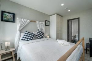 a bedroom with a large bed with blue and white pillows at С1O Новые Рубль ватсап669З582I976 in Nai Yang Beach