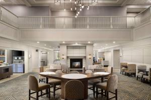 a lobby with a table and chairs and a fireplace at Homewood Suites by Hilton Chester in Chester