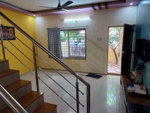 a staircase in a house with a ceiling fan at 2 BHK Row house, WFH in Peaceful place, Wakad 20 Km, Hinjewadi Ph II 25km, Lonavala 29km, Kamshet 12km, Chakan 25 km in Pune