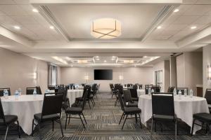 a conference room with tables and chairs and a screen at Homewood Suites by Hilton Chester in Chester