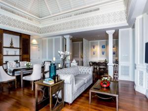 a living room with a couch and a dining room at Novotel Phuket City Phokeethra in Phuket Town