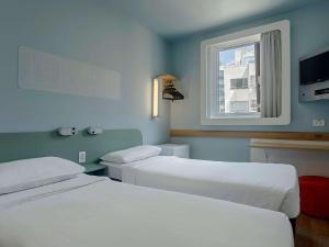 Кровать или кровати в номере ibis budget RJ Praia de Botafogo