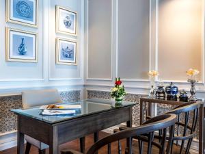 a dining room with a glass table and chairs at Novotel Phuket City Phokeethra in Phuket Town