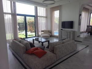 ein Wohnzimmer mit Sofa und Tisch in der Unterkunft H Amelkis in Marrakesch