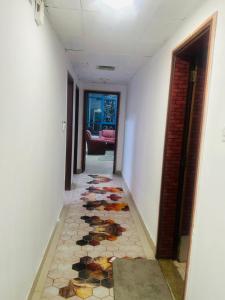 a hallway with a tiled floor in a house at Modern Living Fully Equipped Room For Rent in Ajman 