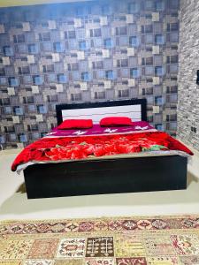 a bedroom with a bed with red pillows on it at Modern Living Fully Equipped Room For Rent in Ajman 