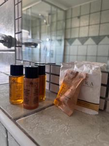 a counter with three bottles of mustard and a bag at Boutique San Daniele B&B in Cirella +133 photos