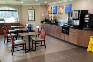 a restaurant with tables and chairs and a counter at Comfort Inn Indianapolis South I-65 in Indianapolis