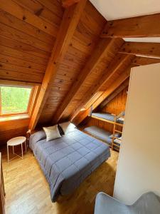 sypialnia z łóżkiem na drewnianym poddaszu w obiekcie Dúplex Pla de L'Ermita (Boí Taüll) w mieście Pla de l'Ermita