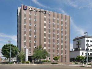 a building with a sign on the top of it at Comfort Hotel Obihiro in Obihiro