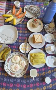 a table with plates of food on a table at Misty View Inn in Ella
