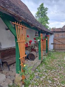 a small house with a gazebo and a bench at Casa Klein in Meşendorf +17 photos