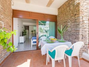 a dining room with a white table and chairs at Bungalows Caribe in Puerto Rico de Gran Canaria