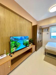A television and/or entertainment centre at Classy Studio Unit at Aspira Towers