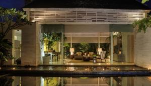 a house with a view of the living room at Kawung Villa in Canggu