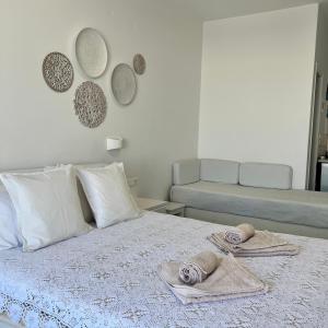 sypialnia z łóżkiem z ręcznikami w obiekcie Vavanos Studios w mieście Nausa
