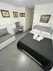 a bedroom with a large bed and a desk at Mykonos Secret Spot in Mýkonos City