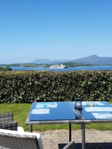 a picnic table with a view of the water at Edencrest B&B in Bantry