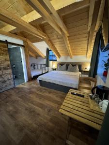 a bedroom with a bed and a wooden ceiling at Penzion Farma Žleby in České Žleby